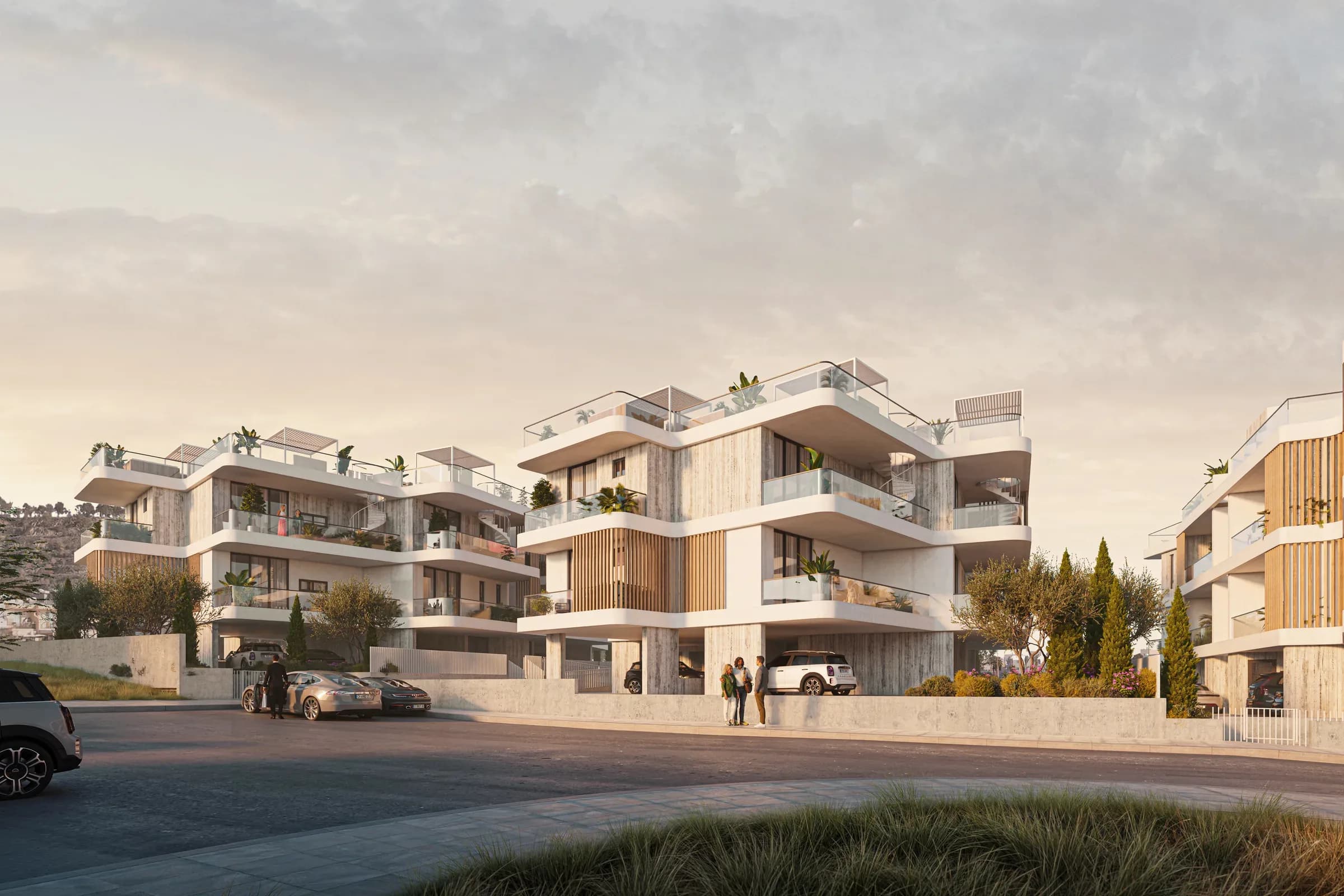 Park Oro from the street at dusk, residents arriving at the entrance