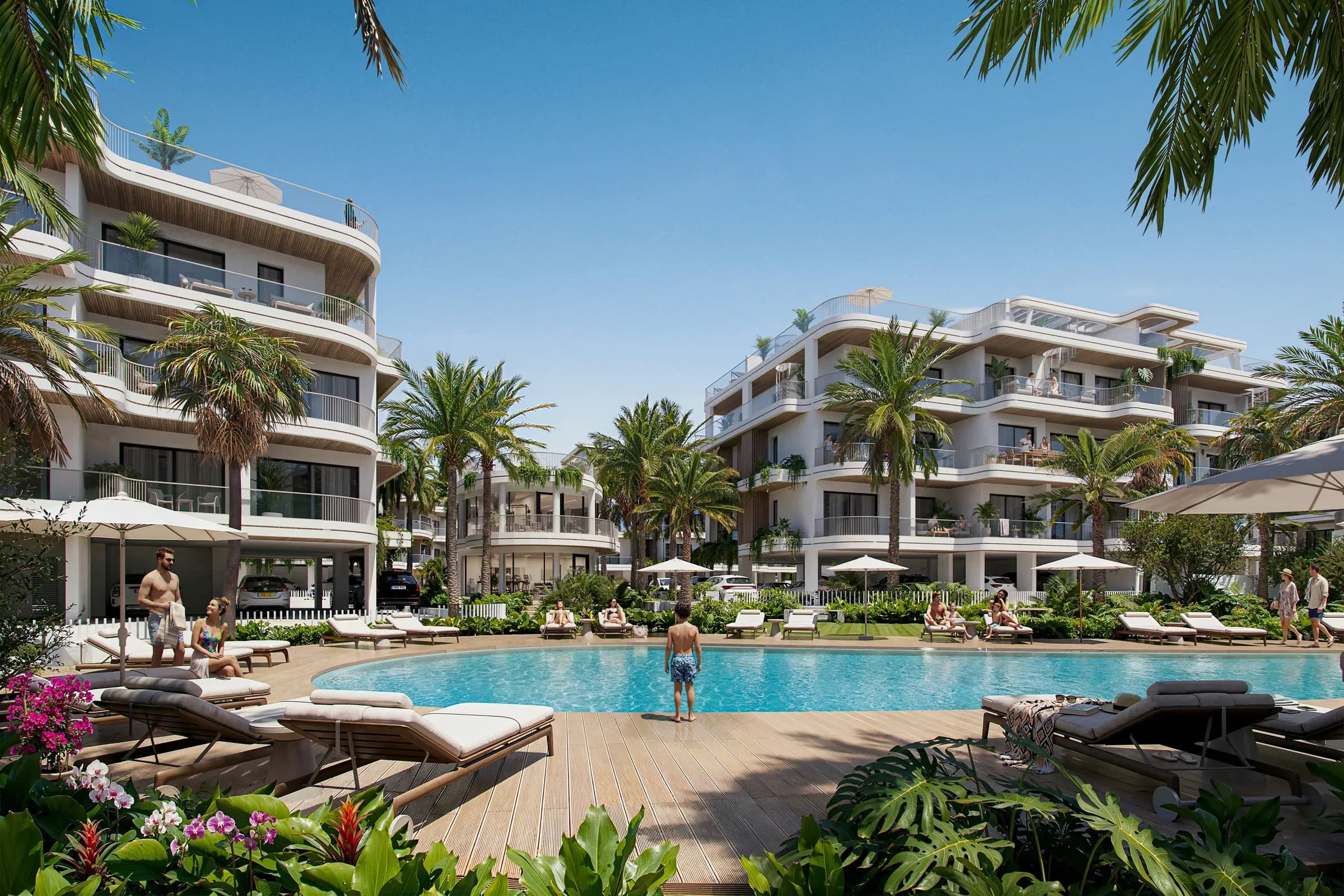The pool at Zin Residences, with loungers and umbrellas below the apartments